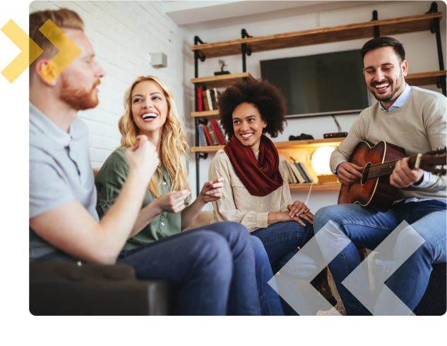 Residents and their guests laughing and enjoying time together inside apartment unit.