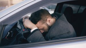 man frustrated in car