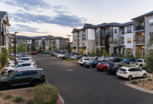 partment parking lot full with no available spaces at dusk