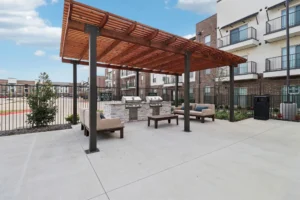 Covered outdoor grilling area with seating at Arden at Corinth, a 296-unit apartment community in Texas