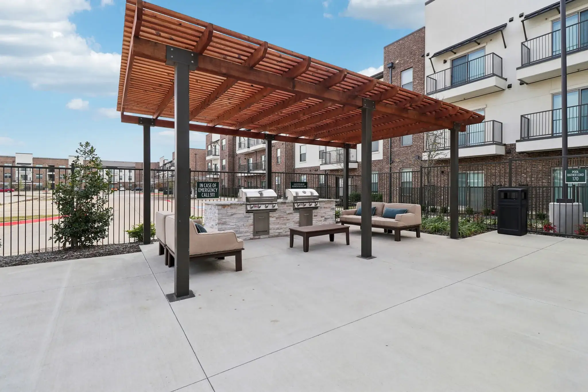 Covered outdoor grilling area with seating at Arden at Corinth, a 296-unit apartment community in Texas