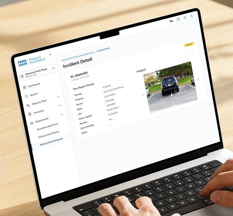 ParkM Property Dashboard on a laptop showing an enforcement incident with tow report details and a vehicle photo