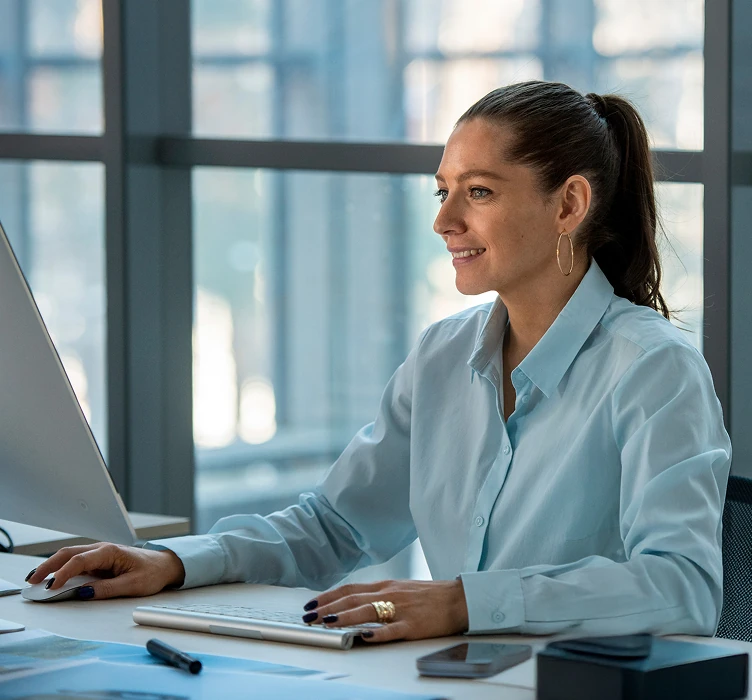 Property manager working at her desktop computer in an office