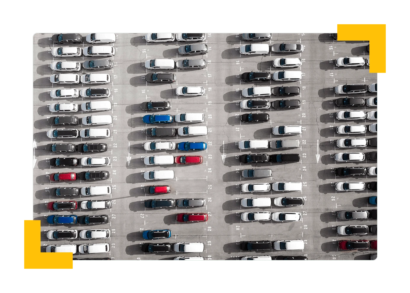 Aerial view of a full parking lot with rows of cars in numbered spaces
