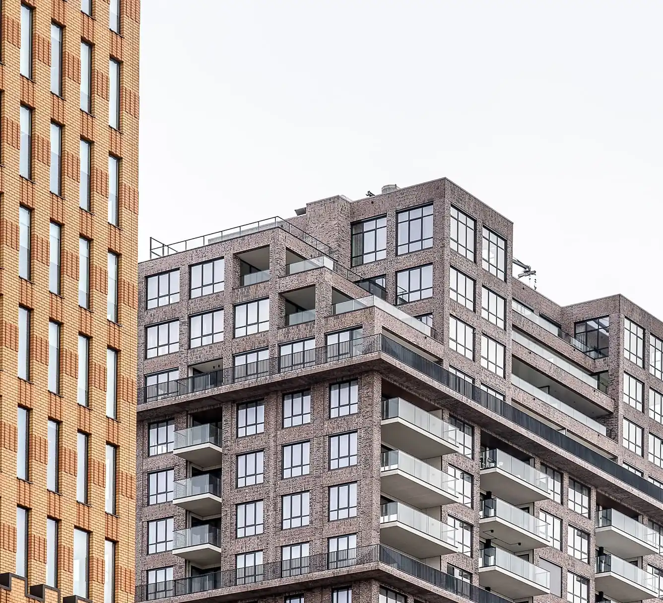 Brick multifamily apartment buildings with rows of balconies