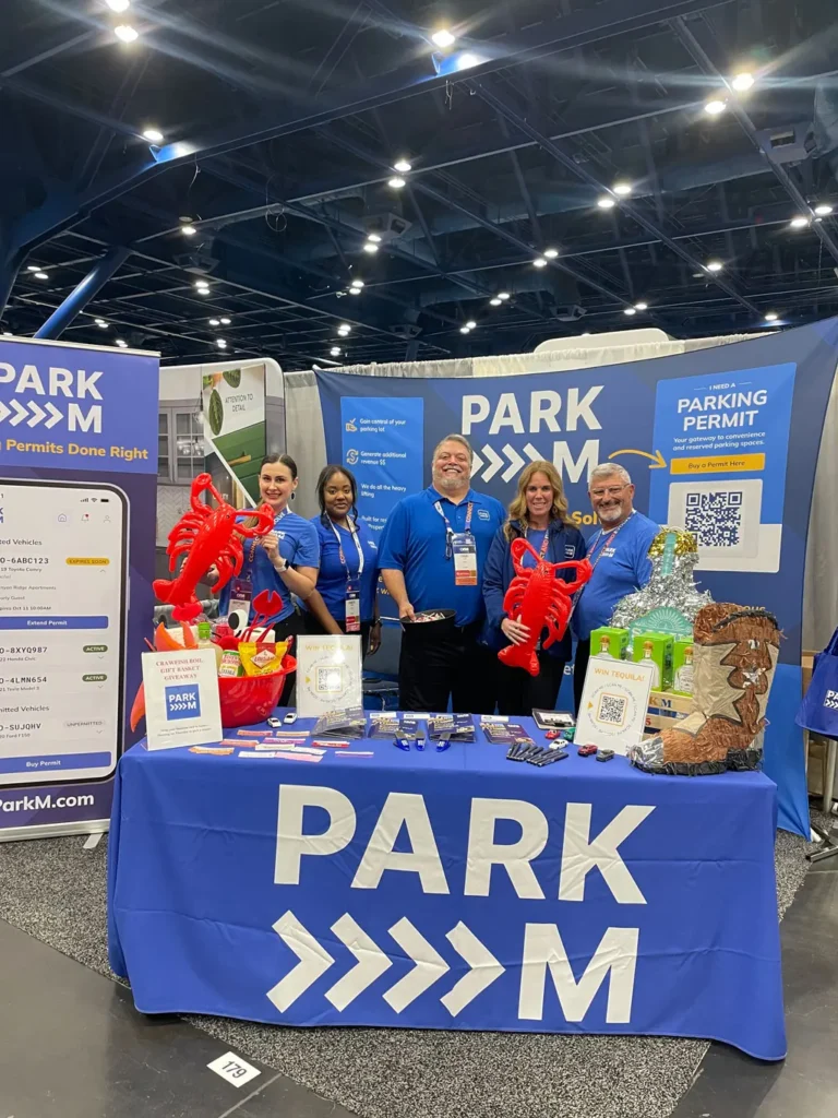 ParkM team at their trade show booth with lobster props and a crawfish boil giveaway